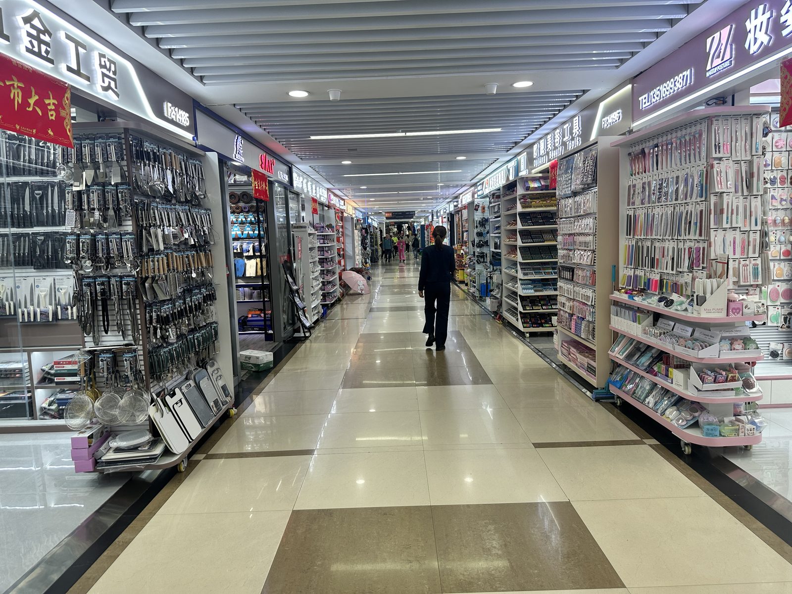 Stationery and party goods booth in a market aisle